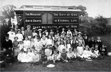 A visiting mission taken with the photographer�s back to the Bull and Butcher and the chapel, on land which is now used for a line of bungalows. The man is the cap is Joseph Ernest Stranks, who was the village shopkeeper at the time