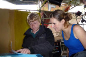 Tommy and Cara from teh sound crew study the running order