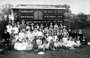 A visiting mission taken with the photographer’s back to the Bull and Butcher and the chapel, on land which is now used for a line of bungalows. The man is the cap is Joseph Ernest Stranks, who was the village shopkeeper at the time